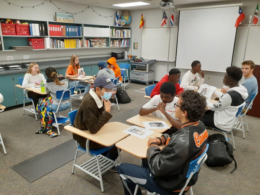 students sitting face to face talking with one another
